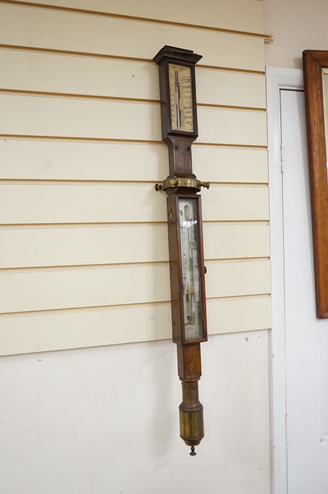 A 19th century oak marine stick barometer by Whyte Thomson, Glasgow, with ‘improved sympiesometer’ and thermometer to the front, with part of the brass gimbal holder still present, 96cm high, CITES Submission reference Y